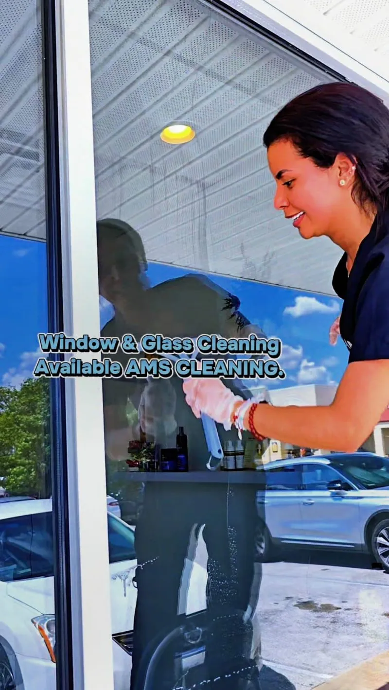 AMS team member cleaning a commercial storefront window